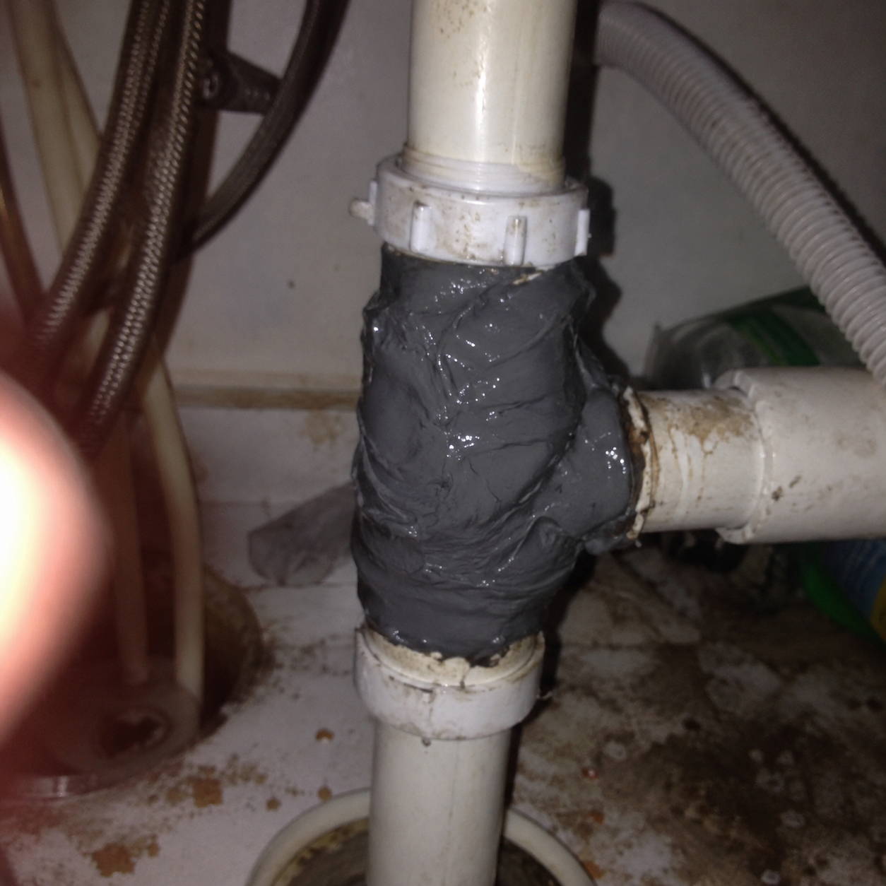 Customer reinforcing a damaged garage drain fitting