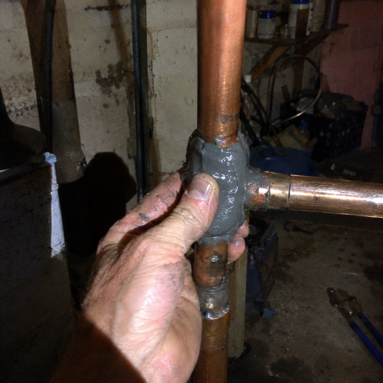 Customer repairing a cracked outdoor drainpipe
