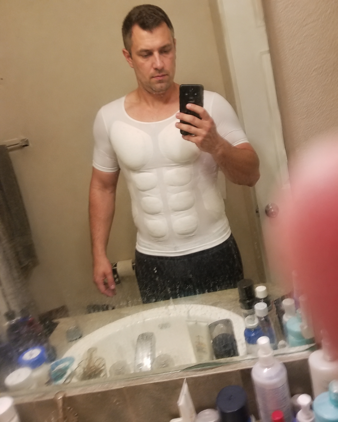 Customer bedroom mirror selfie wearing the muscle shaper