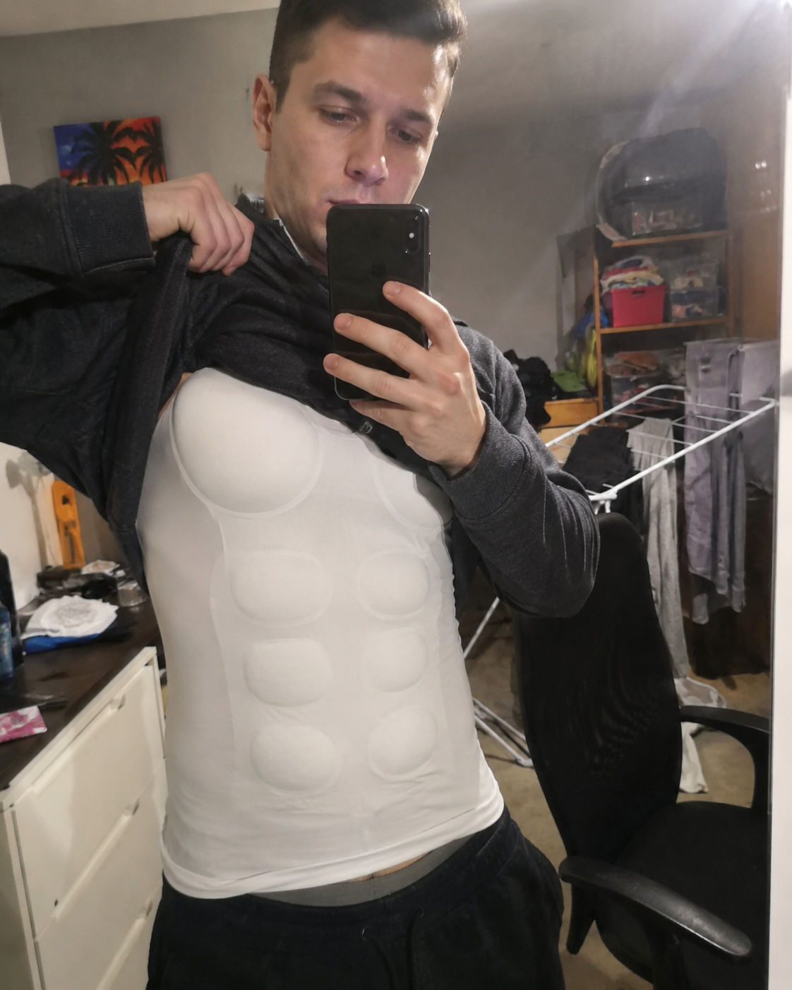 Customer gym locker room selfie wearing the muscle shaper
