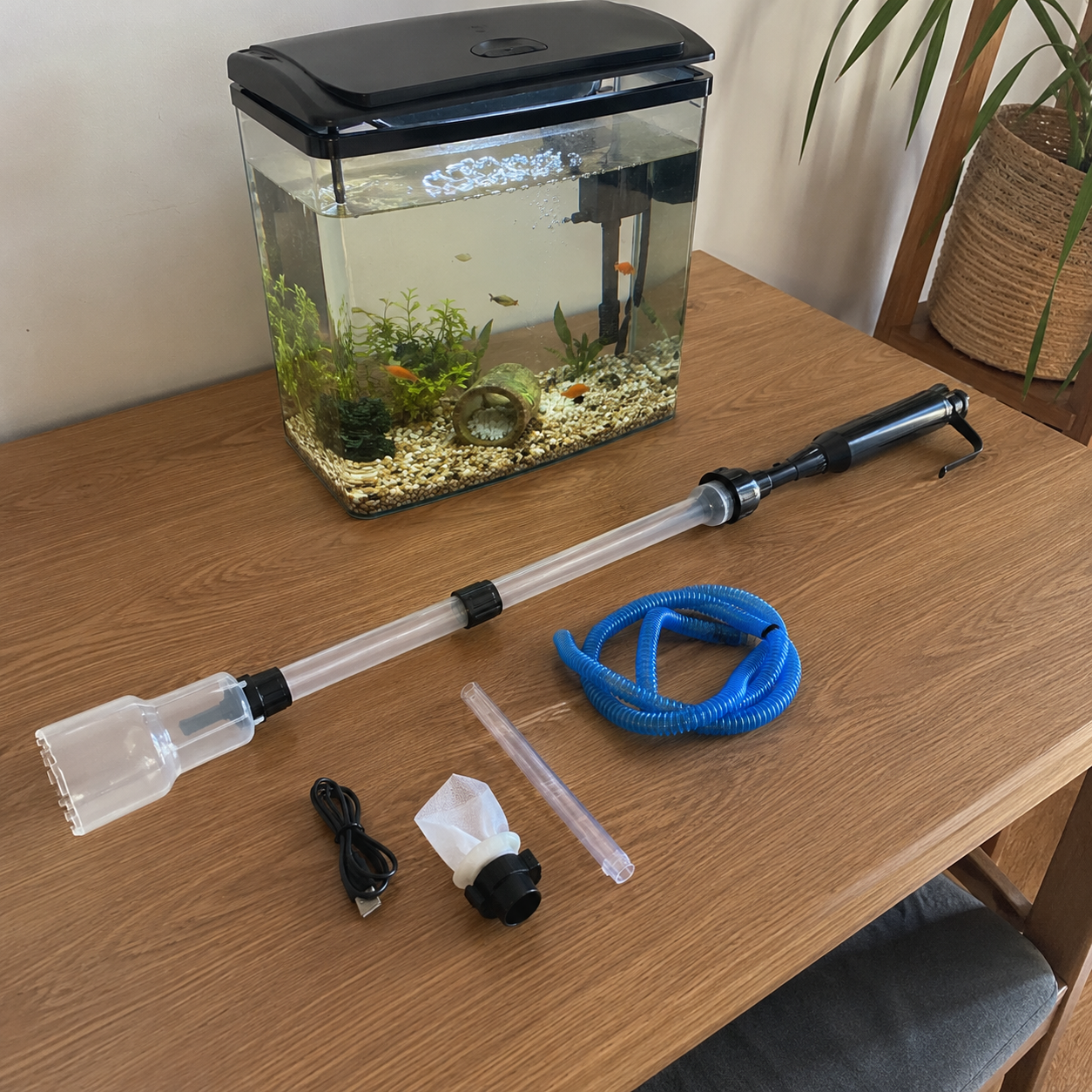 Customer using an electric aquarium gravel cleaner