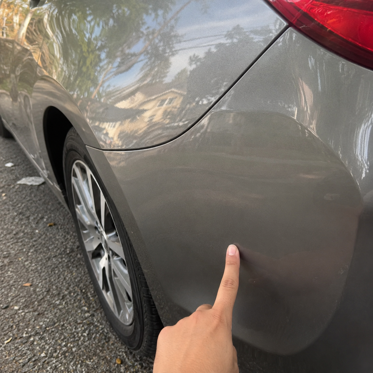 Customer treating light scratches on a car panel