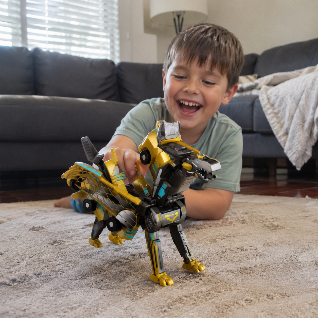 Child playing with the transformer dinosaur and car on the floor