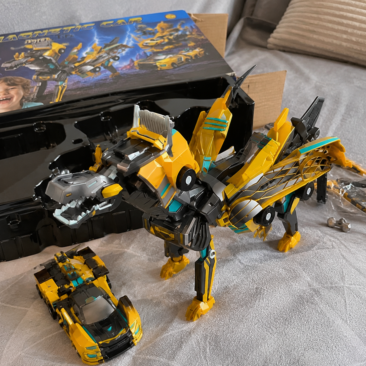 Gold magnetic dinosaur transformer toy displayed after unboxing