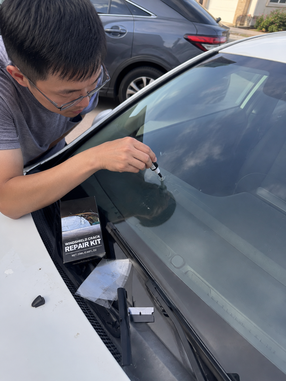 Customer applying windshield repair resin to a small chip