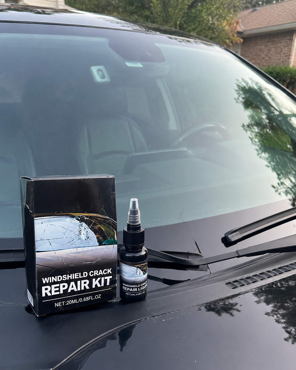 Customer checking the repaired windshield area in daylight