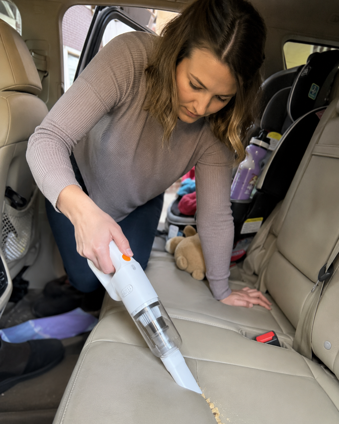 Customer using the lightweight vacuum inside a car