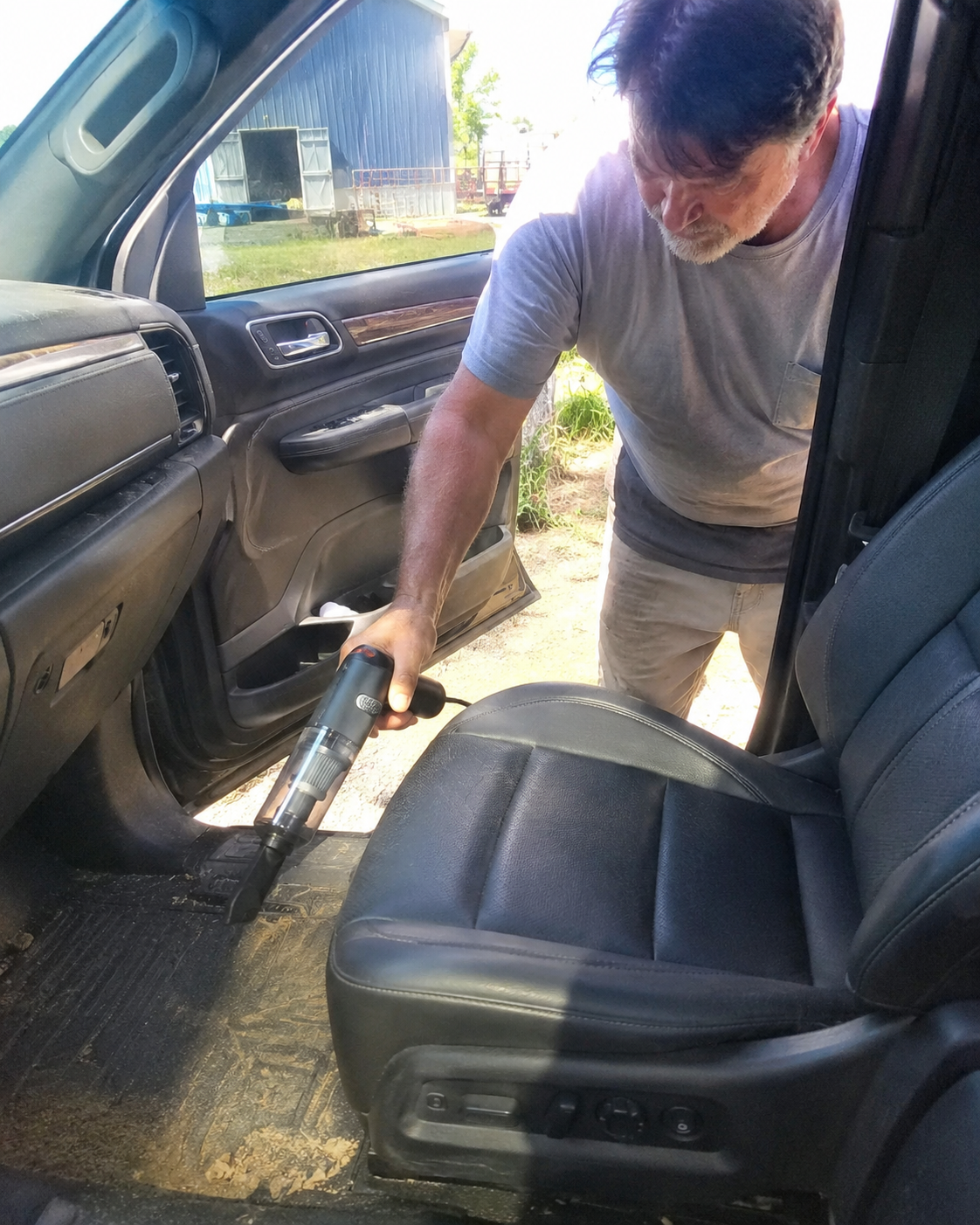 Customer using the cordless vacuum on a vehicle seat