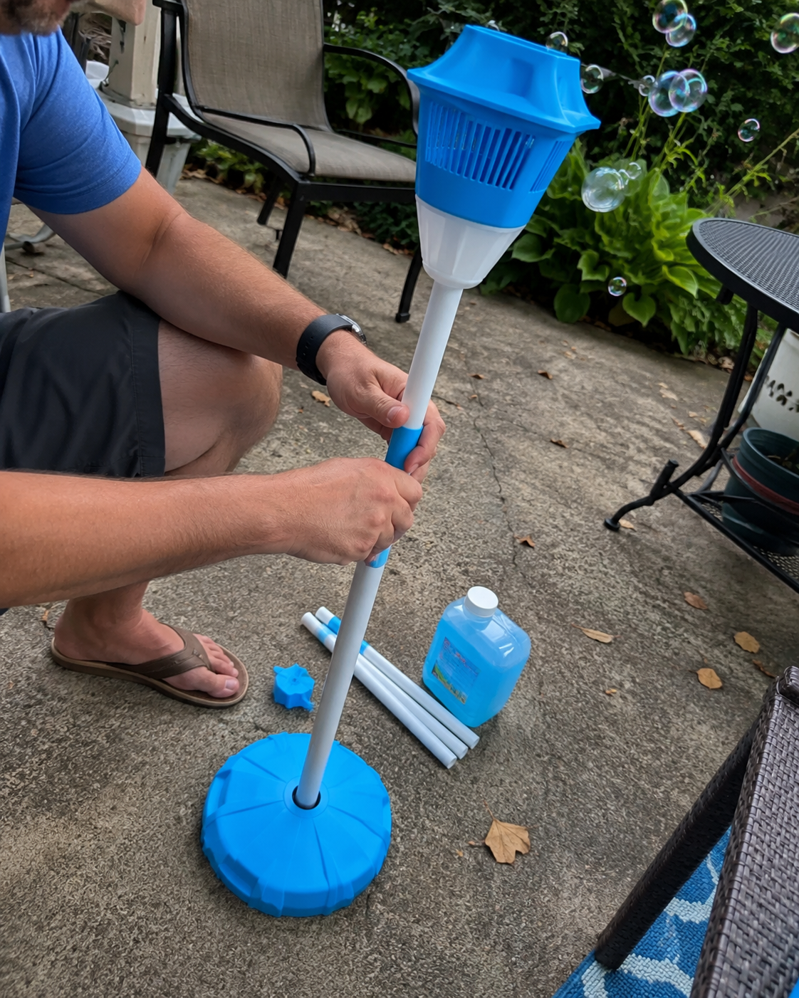 Customer setting up the bubble tower base in a backyard
