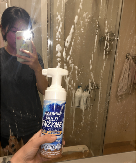 Customer cleaning water spots from a shower glass door