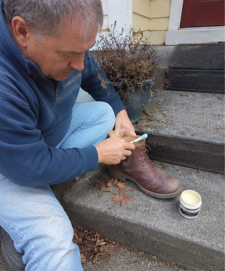 Customer applying leather repair filler to a worn leather surface